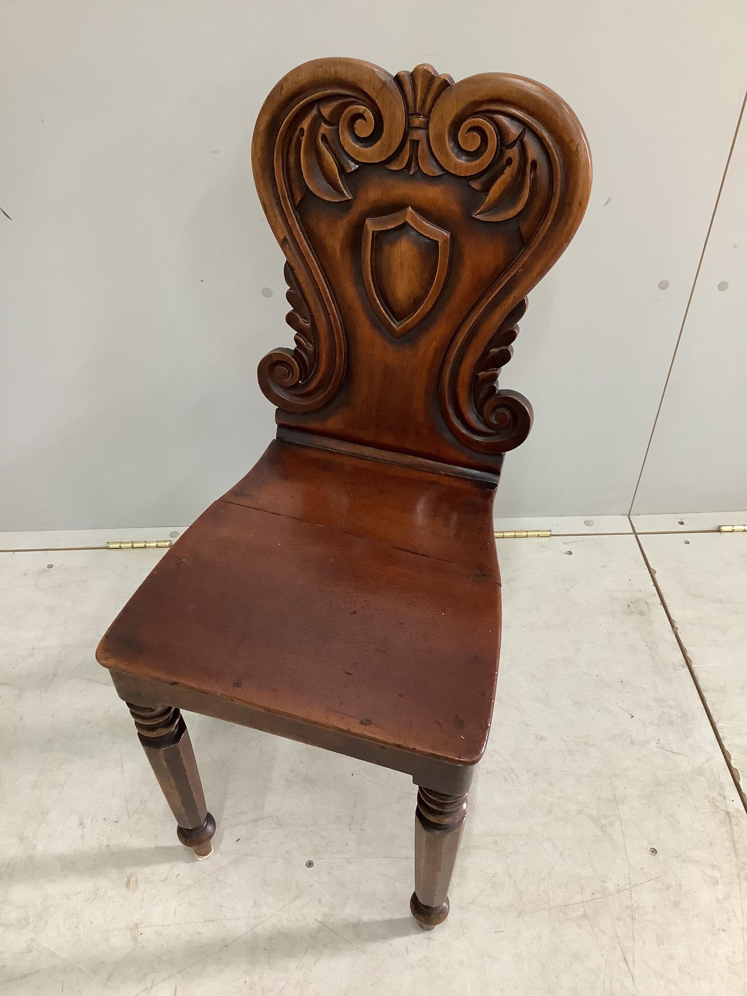A pair of Victorian mahogany hall chairs, width 37cm, height 84cm. Condition - fair